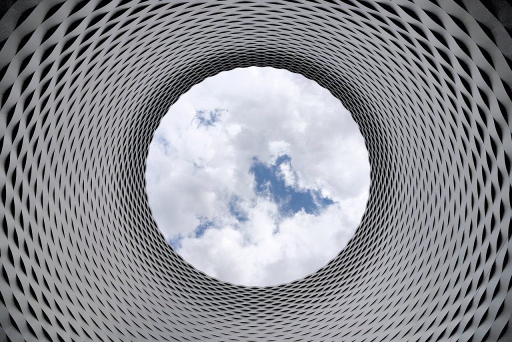 Crafting Captivating Headlines: Your awesome post title goes here Modern architectural tunnel with a geometric pattern revealing a bright sky.
